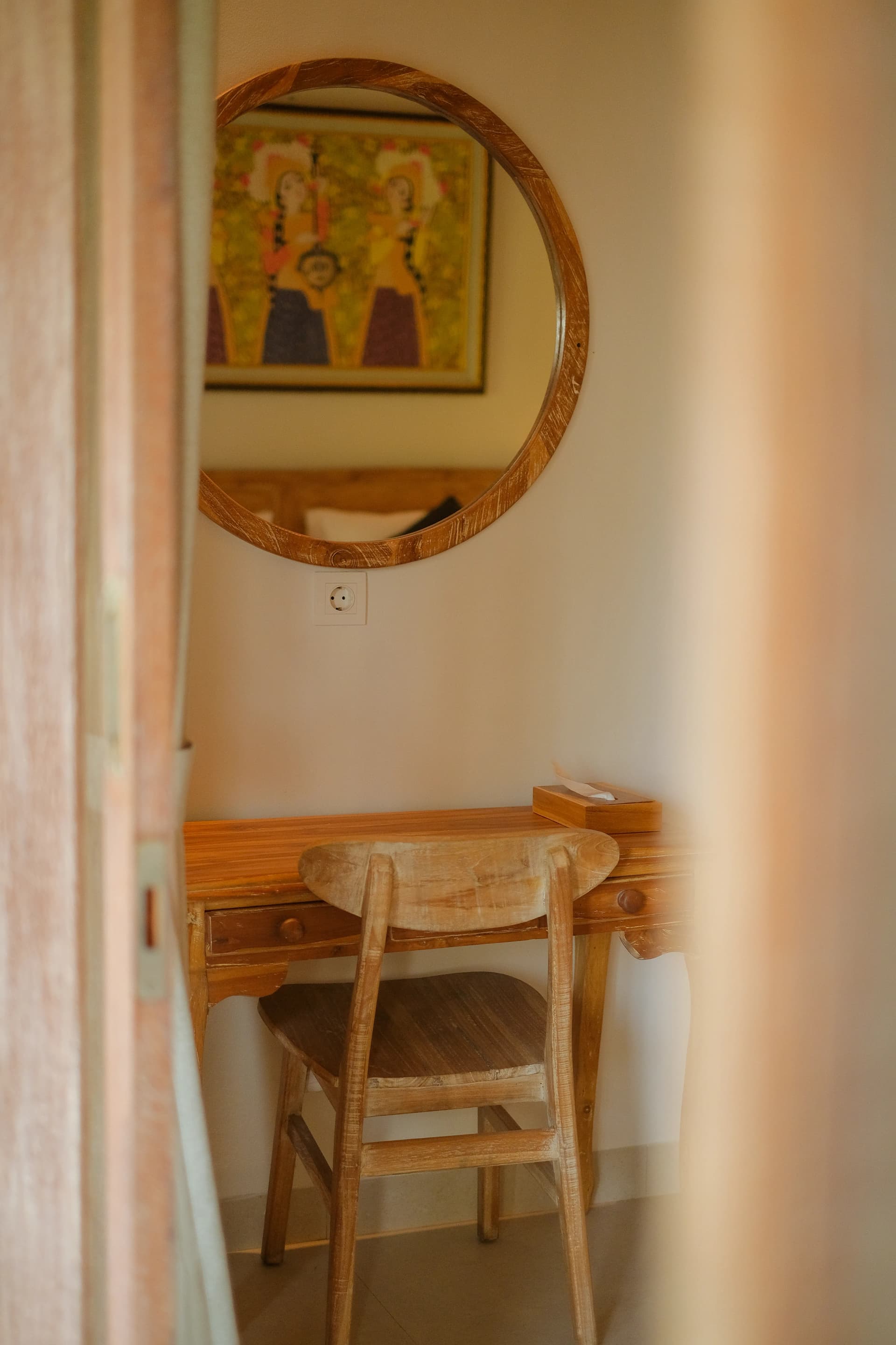 Warm-toned bedroom with balcony overlooking tropical greenery